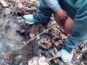 teen pissing in a forest stream after a run