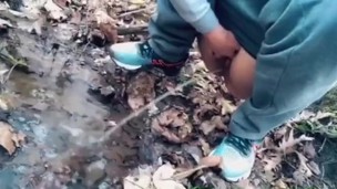 teen pissing in a forest stream after a run