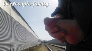 Jerking off and cumming at the railway crossing behind the fence people work