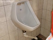 Gril peeing in the urinal
