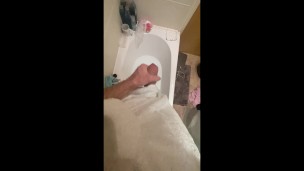 Horny big cock guy wanking in the bath, cumming in bathwater over feet, masturbating uncut big dick