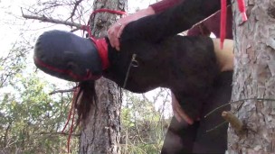 Tied up to a tree outdoor on sexy clothes, wearing pantyhose and high ankle boots heels, rough fuck