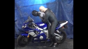 having some fun sitting on the motorcycle with dummy