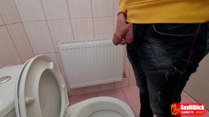 Uncircumcised cock pees on the station toilet