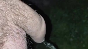 Pissing in the dark outside, uncut cock