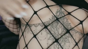 Tatted Babe in Fishnets Plays with Nipples