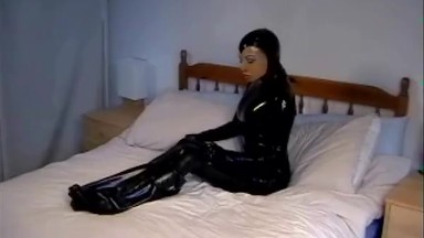 Cute girl in black latex catsuit with mask makes self bondage in rubber vacuum sleepbag - part 1