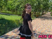 A BEAUTIFUL GIRL IN GLASSES WALKS IN A PARK IN A SHORT SKIRT ATTRACTING THE ATTENTION OF OTHER PEOPL 2/16