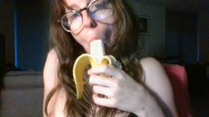 girl with cute glasses sucks banana