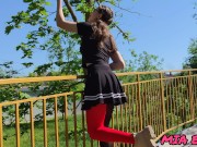 A beautiful girl with glasses walks and seduces people in the park with her look