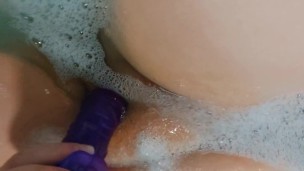 Watch me suck and fuck my purple dildo in the bath