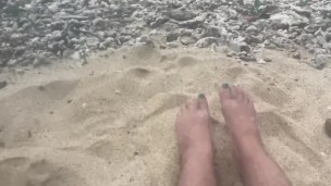 rubbing my feet in the sand on the beach 