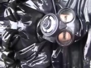 Latex girl full in black rubber and Gasmask chill outs outdoor in garden in a heavy rubber hammock 14/16