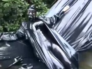 Latex girl full in black rubber and Gasmask chill outs outdoor in garden in a heavy rubber hammock 2/16