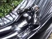 Latex girl full in black rubber and Gasmask chill outs outdoor in garden in a heavy rubber hammock 5/16