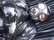 Latex girl full in black rubber and Gasmask chill outs outdoor in garden in a heavy rubber hammock 7/16