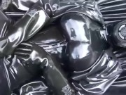 Latex girl full in black rubber and Gasmask chill outs outdoor in garden in a heavy rubber hammock 9/16