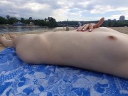Girl caresses herself on a nude beach