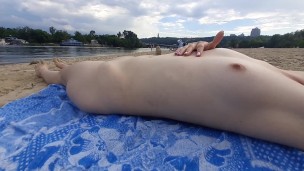 Girl caresses herself on a nude beach