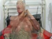 Hot milf with latex condom hood on her head and rubber sheet has fun with breathing games 3/16