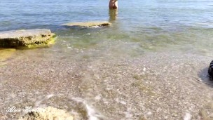 Alice walks naked on an empty nudist beach and enters the water for the first time this year