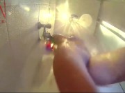 Voyeur camera in the shower. A nude girl in the shower is washed with soap. 16/16