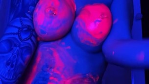 babe in neon in paint plays with pussy