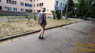 Slut walks in a mini dress with a fully transparent skirt