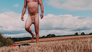 Fat cock and ball weights naked in corn field