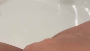 Hot milf alone in her bathroom rubbing her shaved pussy 
