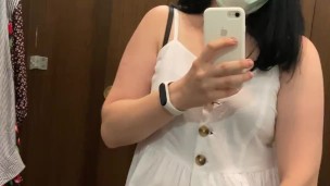 Pregnant beauty masturbates in a clothing store and tries on dresses