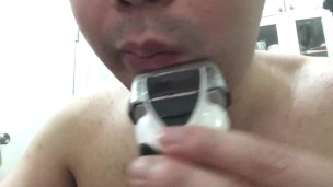 Shaving my beard with a shaver.