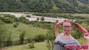 beauty with pink tips walks in nature in the mountains attracting attention to herself