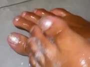 ebony babe soaping up dirty soles in the shower