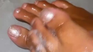ebony babe soaping up dirty soles in the shower