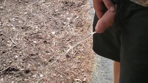 Boy peeing outside cabin