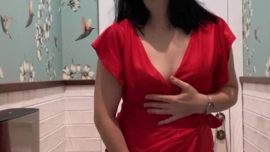 Hot brunette in red dress masturbates in a public restaurant