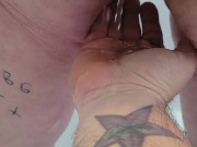 Submissive pisses on owners hand.   