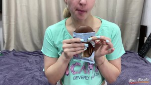 A young woman eats chocolate cookies