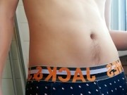 a guy with a beautiful body and a big dick in panties smokes on the balcony