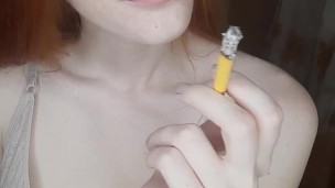 redhead girl smokes a cigarette