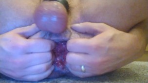Gay guy playing with his rosebud wearing a ball stretcher