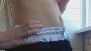 guy is a smoker with a nice body in shorts