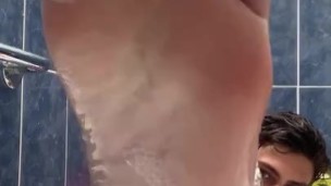 Boy baths & washes feet 