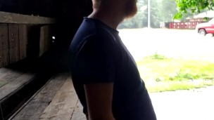 Red headed guy playing with dick outside in the rain while people drive by
