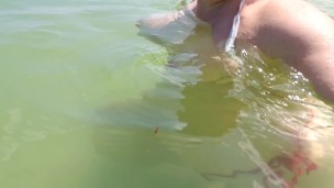 Public beach flashing boobs... tits floating free in the water