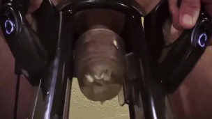 Man moaning while using cock milking machine 
