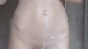 Petite teen knows she's being recorded in the shower