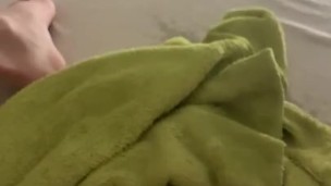 pissing in a high arc from the sofa