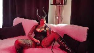 Succubus with big boobs playing with her strap-on and smoking hookah